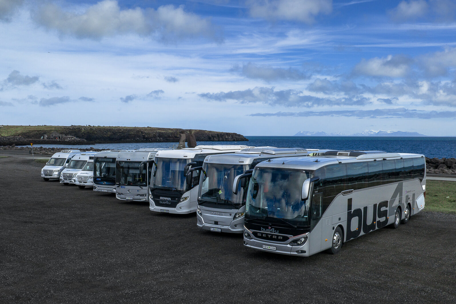 Bus4u fleet of coaches and minibuses parked in a row by the sea